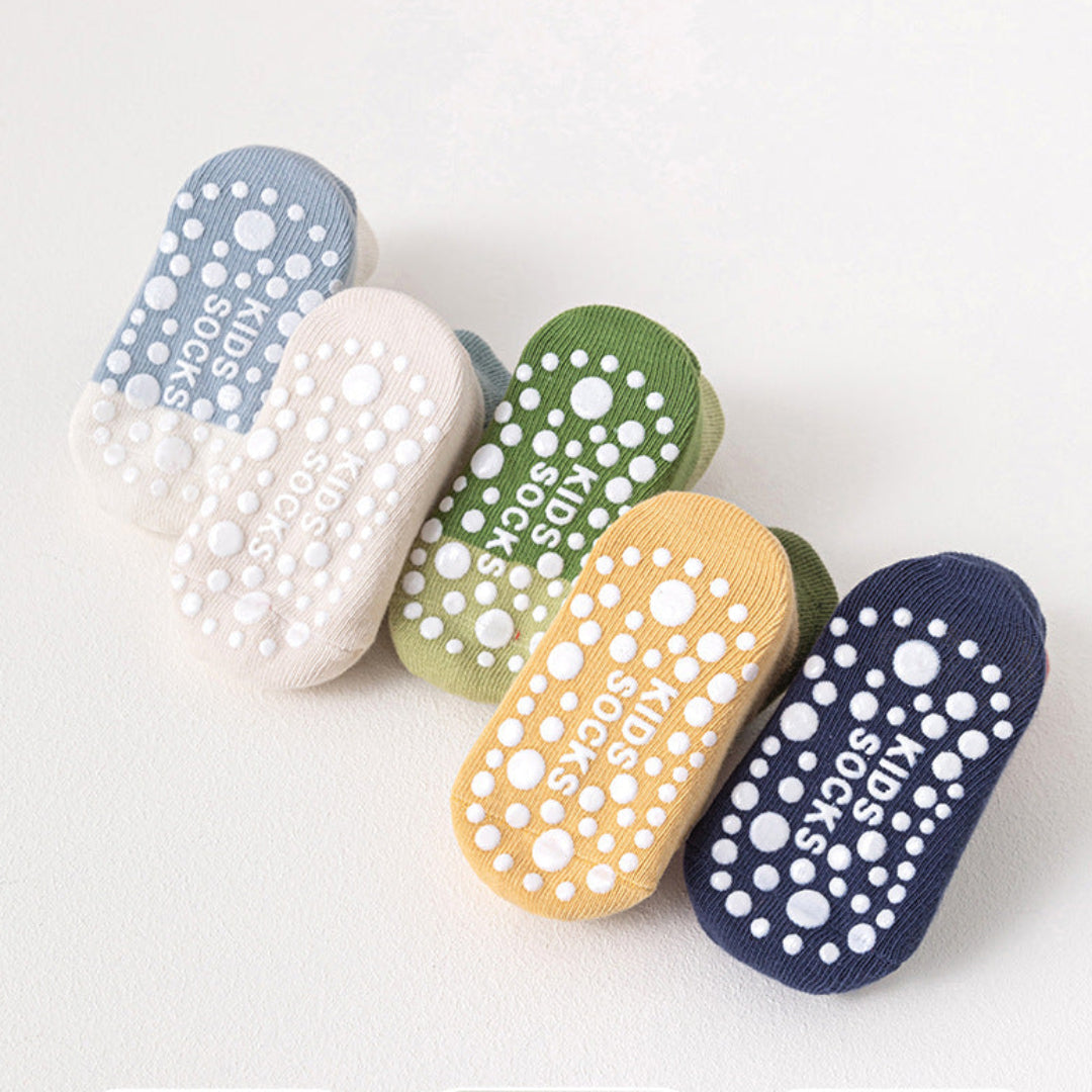 Colorful slippers with text in a language other than English on a white background